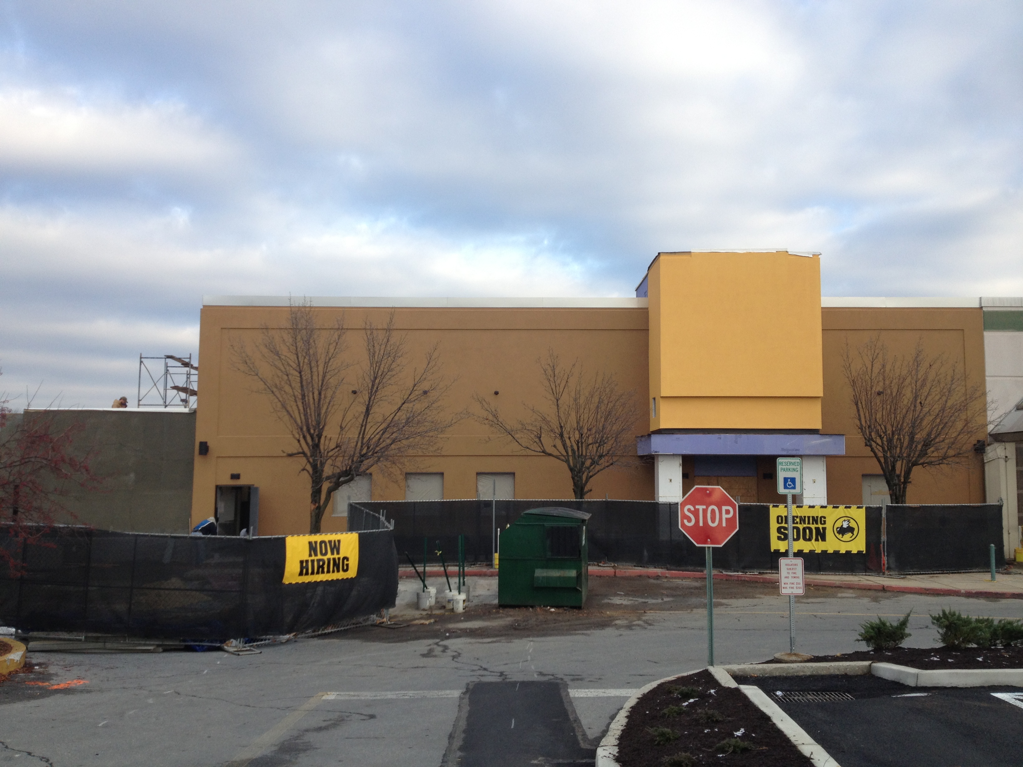 Retail building under construction with opening soon banners